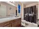 Bathroom with granite countertops, new cabinets, and a shower with a unique 