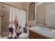 Bathroom showcasing granite counters, a shower with floral curtain, and neutral tones at 261 Crimson Edge St, Henderson, NV 89012