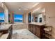 Bathroom with dual sinks, granite countertops, walk-in closet, and large windows at 261 Crimson Edge St, Henderson, NV 89012