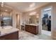 Spacious bathroom featuring dual vanities, granite countertops, a glass-enclosed shower, and a large walk-in closet at 261 Crimson Edge St, Henderson, NV 89012