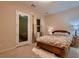 Bedroom featuring a wood bed, a door leading outside, and neutral decor at 261 Crimson Edge St, Henderson, NV 89012