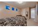 A bright bedroom featuring neutral tones, carpet flooring, modern light fixture, and a small desk at 261 Crimson Edge St, Henderson, NV 89012