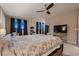Bright, open bedroom featuring large windows, ceiling fan, and carpeted floors at 261 Crimson Edge St, Henderson, NV 89012