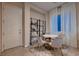 Cozy breakfast nook with a marble table and plush chairs, bathed in natural light at 261 Crimson Edge St, Henderson, NV 89012
