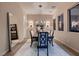 Formal dining room with chandelier, large mirror and two windows providing natural light at 261 Crimson Edge St, Henderson, NV 89012