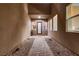 Stylish entryway with tiled pathway, rock landscaping, and large windows at 261 Crimson Edge St, Henderson, NV 89012