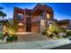 Modern two-story home showcasing stone accents, a two-car garage, and desert landscaping at 261 Crimson Edge St, Henderson, NV 89012