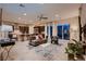 Open-concept living room with modern decor, large windows, and seamless kitchen access at 261 Crimson Edge St, Henderson, NV 89012
