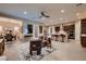 Open concept living area with modern furnishings flowing into a kitchen with stainless steel appliances at 261 Crimson Edge St, Henderson, NV 89012