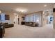Bright, expansive living room area with neutral tones, carpet flooring, and comfortable furniture at 261 Crimson Edge St, Henderson, NV 89012