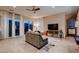 Bright living room featuring tile floors, modern sofa, and access to outdoor patio at 261 Crimson Edge St, Henderson, NV 89012