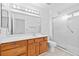 Clean bathroom with a large mirror, vanity, and a shower-tub combination with a sliding glass door at 3021 Lotus Hill Dr, Las Vegas, NV 89134