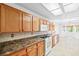 Traditional kitchen with light wood cabinets, tile backsplash, and white appliances at 3021 Lotus Hill Dr, Las Vegas, NV 89134