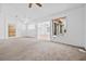 Spacious living room with neutral carpeting and ample natural light from the windows at 3021 Lotus Hill Dr, Las Vegas, NV 89134