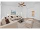 Bright living room featuring neutral décor, comfortable seating, and a ceiling fan at 3021 Lotus Hill Dr, Las Vegas, NV 89134