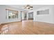 Open-concept living area featuring wood floors, sliding glass doors, and plenty of natural light at 3021 Lotus Hill Dr, Las Vegas, NV 89134
