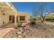 Spacious covered patio area with gravel landscaping and natural rock decor at 3021 Lotus Hill Dr, Las Vegas, NV 89134