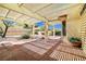 Covered patio with brick flooring and a view of the landscaped backyard, perfect for outdoor relaxation at 3021 Lotus Hill Dr, Las Vegas, NV 89134