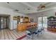 Spacious clubhouse featuring a bar area, tables, and a bookshelf filled with reading options, all with a pool view at 3150 Soft Breezes Dr # 2018, Las Vegas, NV 89128