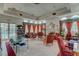 Elegant clubhouse interior with cozy seating, a fireplace, and large windows overlooking the inviting outdoor pool at 3150 Soft Breezes Dr # 2018, Las Vegas, NV 89128