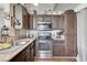 Kitchen with stainless steel appliances and wood cabinetry at 3150 Soft Breezes Dr # 2018, Las Vegas, NV 89128