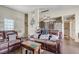 Inviting living room featuring wood floors and a comfortable brown leather sofa at 3150 Soft Breezes Dr # 2018, Las Vegas, NV 89128