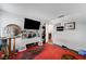 The carpeted room includes wall decorations, plenty of seating and storage space and leads into the kitchen at 3150 Soft Breezes Dr # 2018, Las Vegas, NV 89128