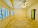 Bedroom featuring plantation shutters, a ceiling fan, and a closet at 3538 Old Course St, Las Vegas, NV 89122