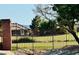 Beautiful community featuring lush green spaces and a secure metal fence with scenic mountain views at 3538 Old Course St, Las Vegas, NV 89122