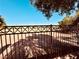 Back view of secure metal fence around the perimeter of a lovely community offering safety and seclusion at 3538 Old Course St, Las Vegas, NV 89122