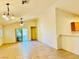 Spacious living room with tile flooring, a ceiling fan, and sliding glass doors to the backyard at 3538 Old Course St, Las Vegas, NV 89122