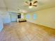 Large living room with tile floors, neutral walls, and ample natural light from the windows at 3538 Old Course St, Las Vegas, NV 89122