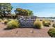 Stone monument at Stallion Mountain Golf Club surrounded by desert landscaping and lush green bushes at 3538 Old Course St, Las Vegas, NV 89122