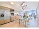 Modern kitchen with stainless steel appliances, a glass dining table, and expansive windows at 3726 Las Vegas Blvd # 2605, Las Vegas, NV 89158