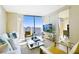 Bright living room featuring a sleek white sofa, modern furniture, and a stunning city view at 3726 Las Vegas Blvd # 2605, Las Vegas, NV 89158