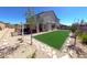 Charming backyard featuring a covered patio, gravel landscaping and artificial turf at 3921 Jacob Lake Cir, Las Vegas, NV 89118