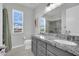 Bright bathroom with double sinks, granite counters, and shower with tiled walls at 3921 Jacob Lake Cir, Las Vegas, NV 89118