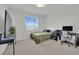 Bedroom featuring a green bed with gray covers, desk and chair, and large TV at 3921 Jacob Lake Cir, Las Vegas, NV 89118