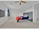 Bright bedroom featuring a large headboard, ceiling fan, and natural light from a window at 3921 Jacob Lake Cir, Las Vegas, NV 89118