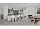 Open-concept kitchen featuring bar seating, sleek appliances, and view to the dining area at 3921 Jacob Lake Cir, Las Vegas, NV 89118