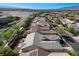 Aerial view of the home in its neighborhood showing its roof and the surrounding homes at 4137 Cackling Goose Dr, North Las Vegas, NV 89084