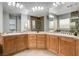 A spacious bathroom features a tiled floor, shower stall, double vanity, and large mirrors creating an open, airy feel at 4137 Cackling Goose Dr, North Las Vegas, NV 89084
