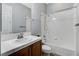 Bathroom features vanity with white countertop, framed mirror, and shower-tub combo at 4137 Cackling Goose Dr, North Las Vegas, NV 89084