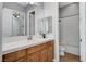 Well-lit bathroom features a wood vanity with a white tiled countertop and shower with a tub at 4137 Cackling Goose Dr, North Las Vegas, NV 89084