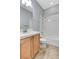 Bathroom featuring a white shower-tub combination, single sink vanity with framed mirror at 4137 Cackling Goose Dr, North Las Vegas, NV 89084