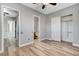 Bedroom features wood-look floors, neutral walls, open bathroom, and sliding closet doors at 4137 Cackling Goose Dr, North Las Vegas, NV 89084