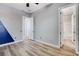 Neutral bedroom features wood-look floors and ensuite bathroom with white trim at 4137 Cackling Goose Dr, North Las Vegas, NV 89084