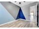 Spacious bedroom with wood-look floors, geometric accent wall, and modern ceiling fan at 4137 Cackling Goose Dr, North Las Vegas, NV 89084