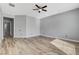 Large bedroom with a ceiling fan, recessed lights, and wood floors create a bright and inviting space at 4137 Cackling Goose Dr, North Las Vegas, NV 89084