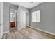 Bedroom featuring wood-look floors, neutral walls, and a closet across the room at 4137 Cackling Goose Dr, North Las Vegas, NV 89084